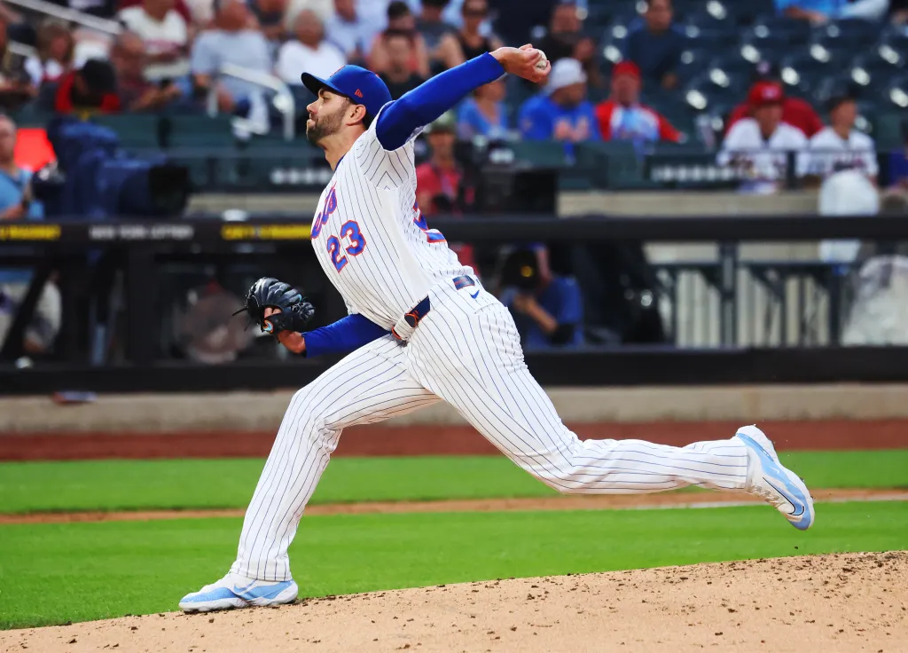 New York Mets pitcher David Peterson mid-pitch during a game against the St. Louis Cardinals.