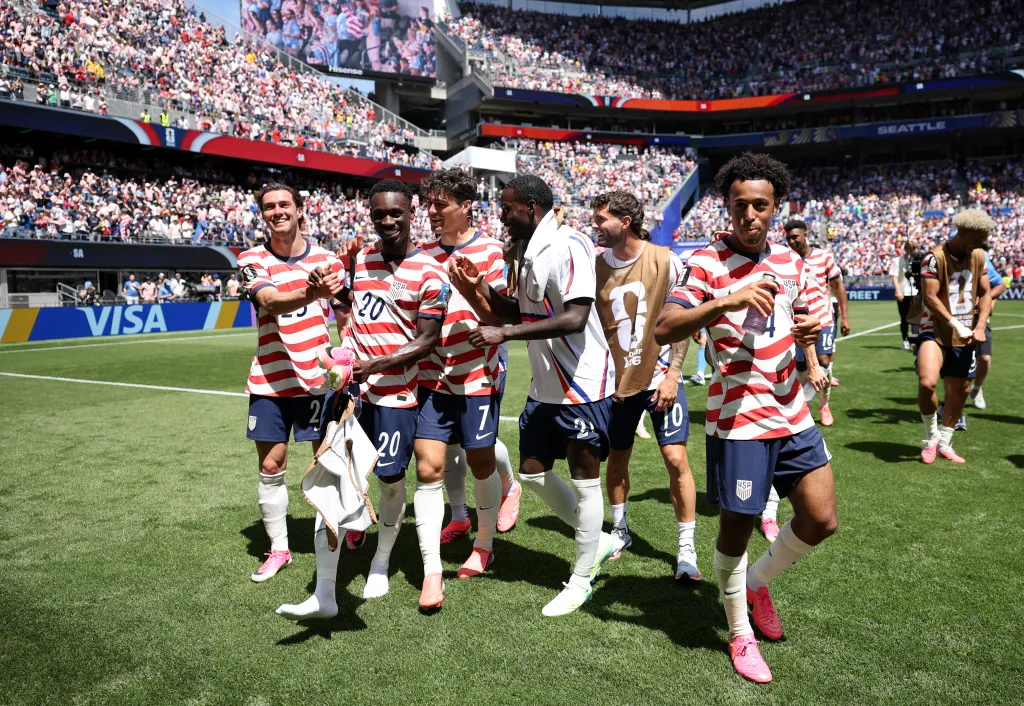 US soccer players applaud fans after a 2-0 victory against Australia.