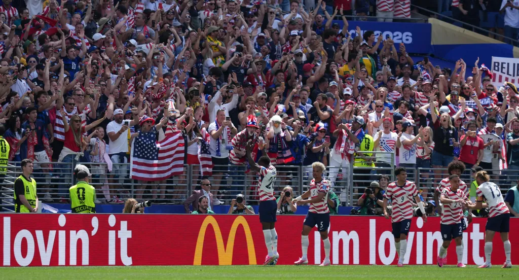 Players from the United States celebrate a goal as fans cheer in the stands during the 2026 FIFA World Cup.