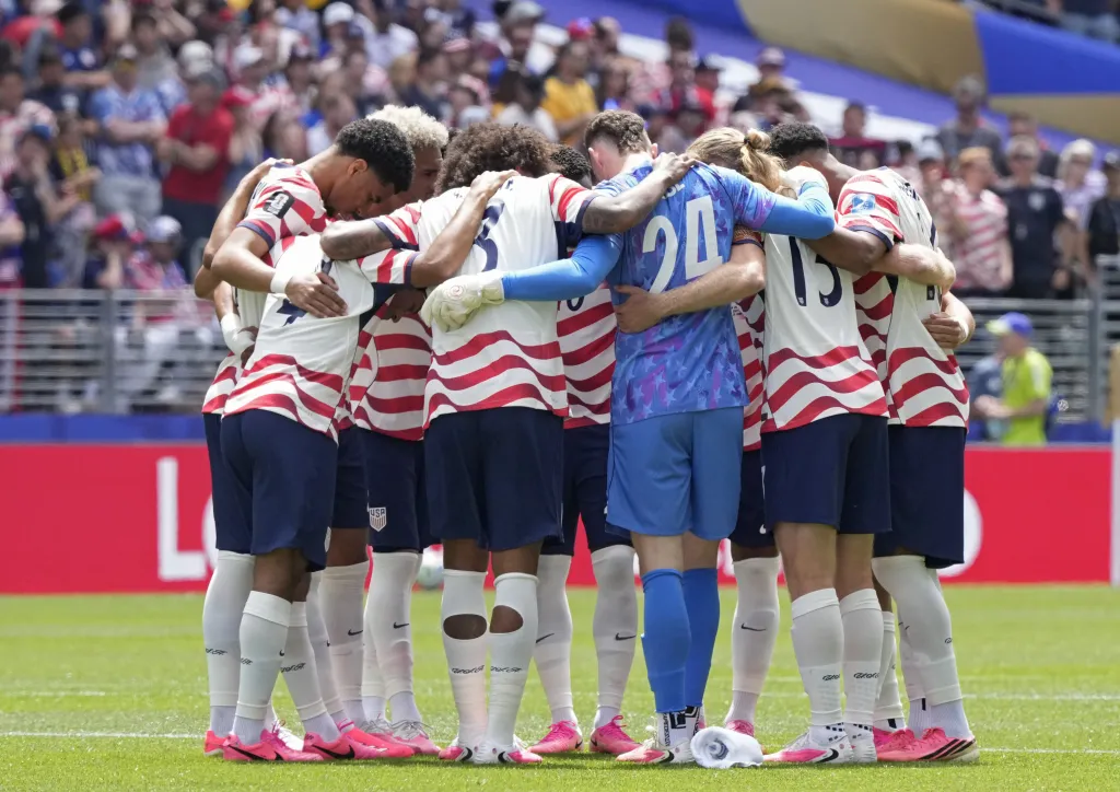 USA soccer players huddle together before the FIFA World Cup 2026 group stage match against Australia.