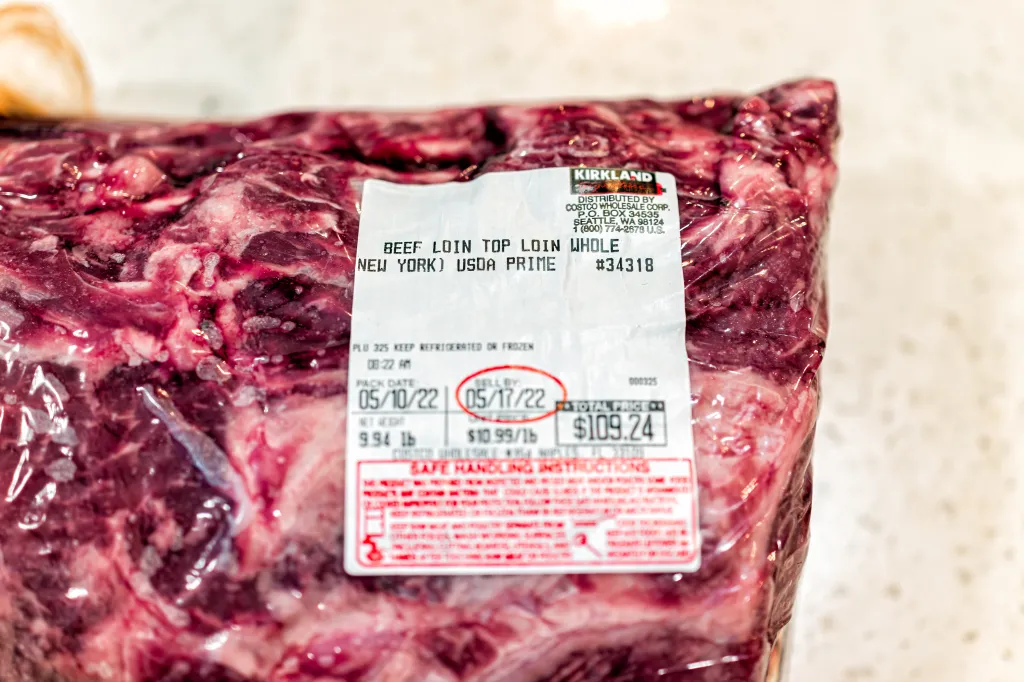 A vacuum-sealed package of Kirkland Signature beef top loin from Costco, with a sell-by date of May 17, 2022, and a price of $109.24.
