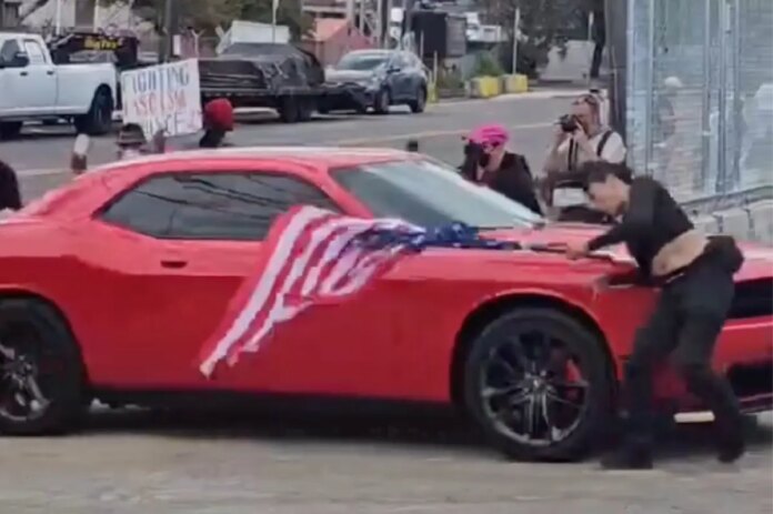 protester-hit-car-entering-ice-131831608.jpg