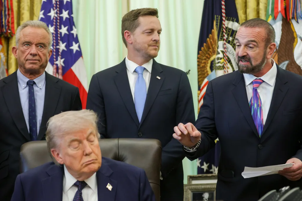 George Yancopoulos speaks next to Robert F. Kennedy Jr., Chris Klomp, and Donald Trump at a White House event.