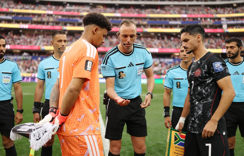 Referee Joao Pinheiro conducting the coin toss with South Africa's Ronwen Williams and Canada's Stephen Eustaquio before the FIFA World Cup 2026 match.