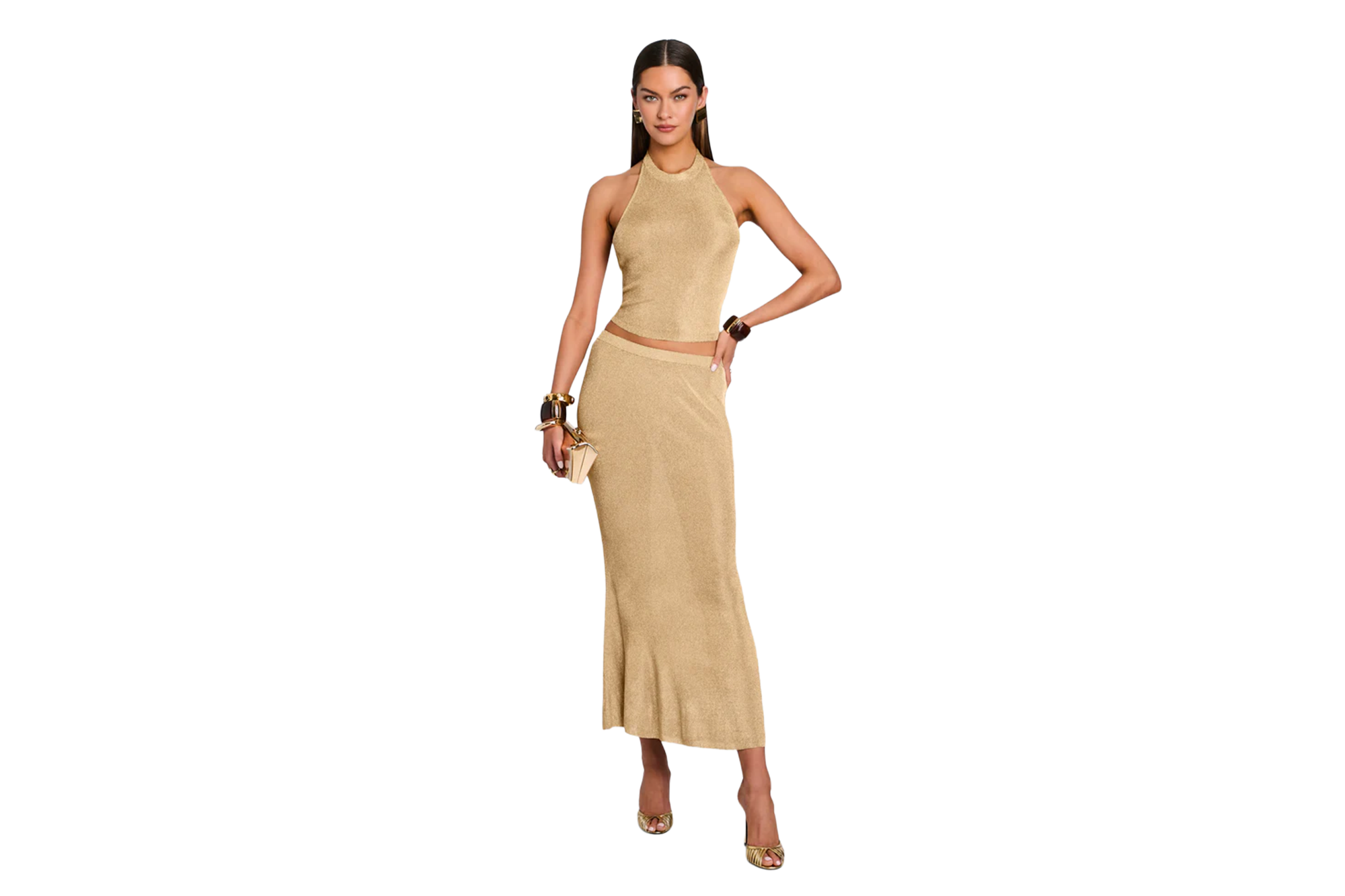 Model wearing a Retrofete gold knit halter top and matching midi skirt.