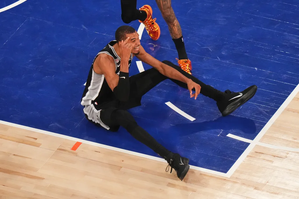 Victor Wembanyama of the San Antonio Spurs sits on the court after being knocked down during Game 4 of NBA Finals