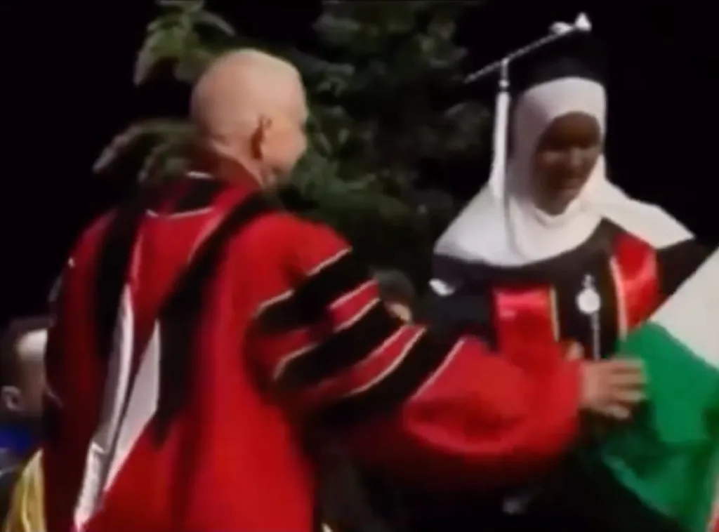 A Seattle University official yanking a Palestinian flag from a graduating student during a commencement ceremony.