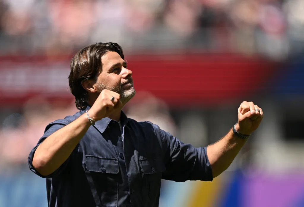 US coach Mauricio Pochettino celebrates after the match, pumping his fists.