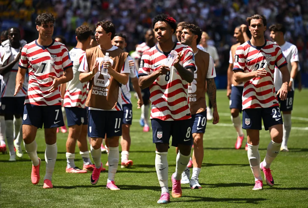 Weston McKennie and his teammates applaud fans after a match.
