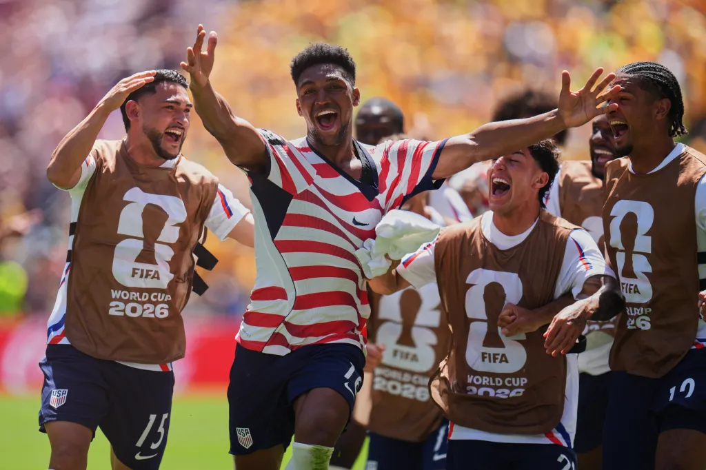 Alex Freeman and teammates celebrate after scoring the second goal for the United States during a World Cup Group D soccer match.