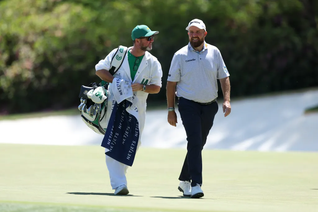Shane Lowry and his caddie Darren Reynolds walking on the golf course during The Masters.