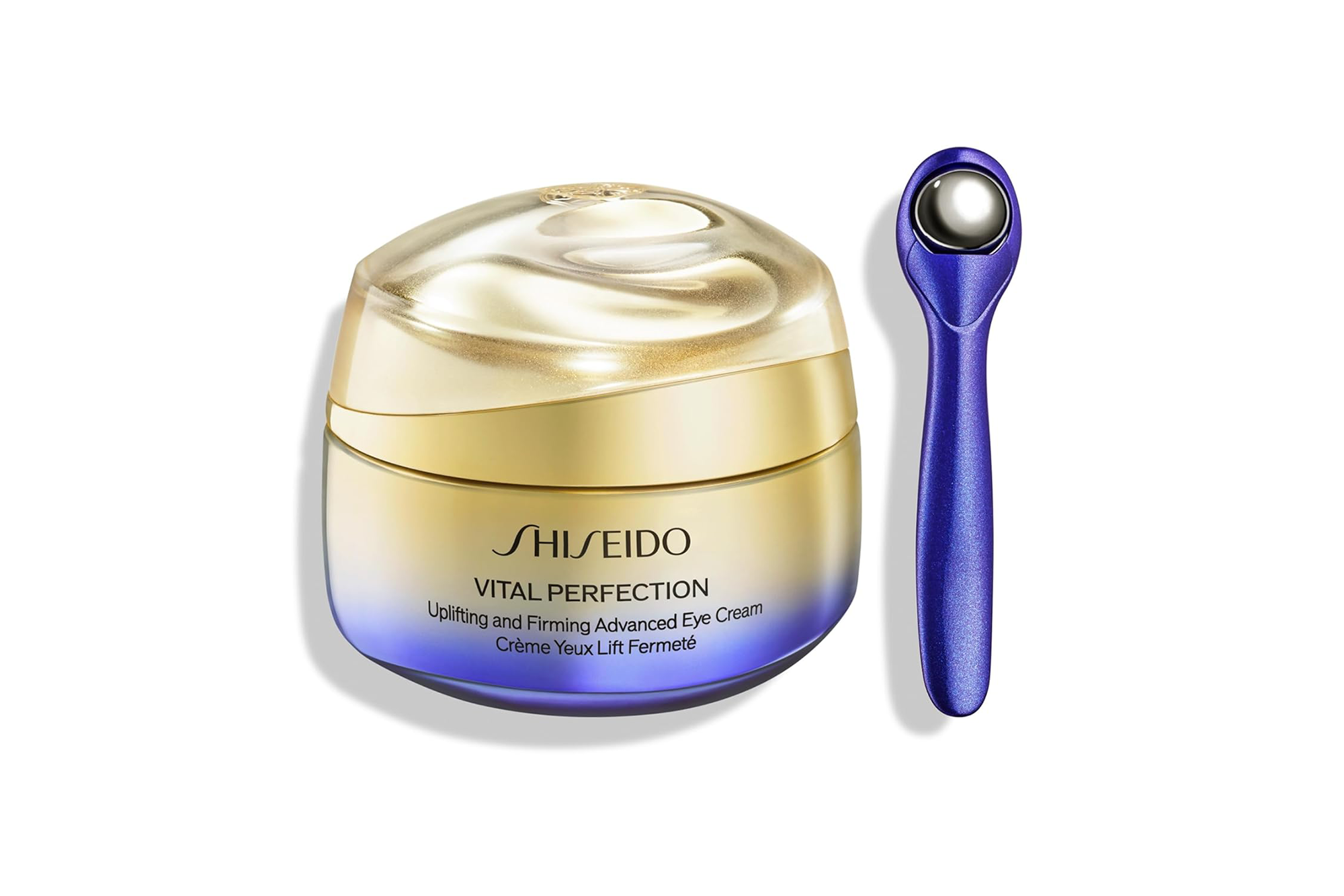 Shiseido Vital Perfection Uplifting and Firming Advanced Eye Cream jar with an eye massager tool.