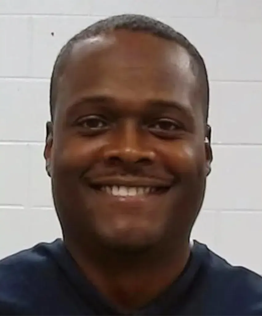 Sholdon Daniels smiling in a mugshot.