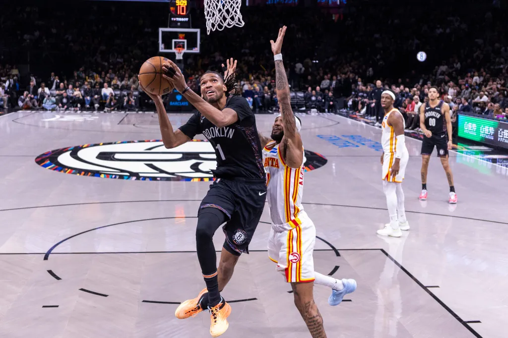 Brooklyn Nets forward Ziaire Williams shoots the ball over Atlanta Hawks guard Nickeil Alexander-Walker.
