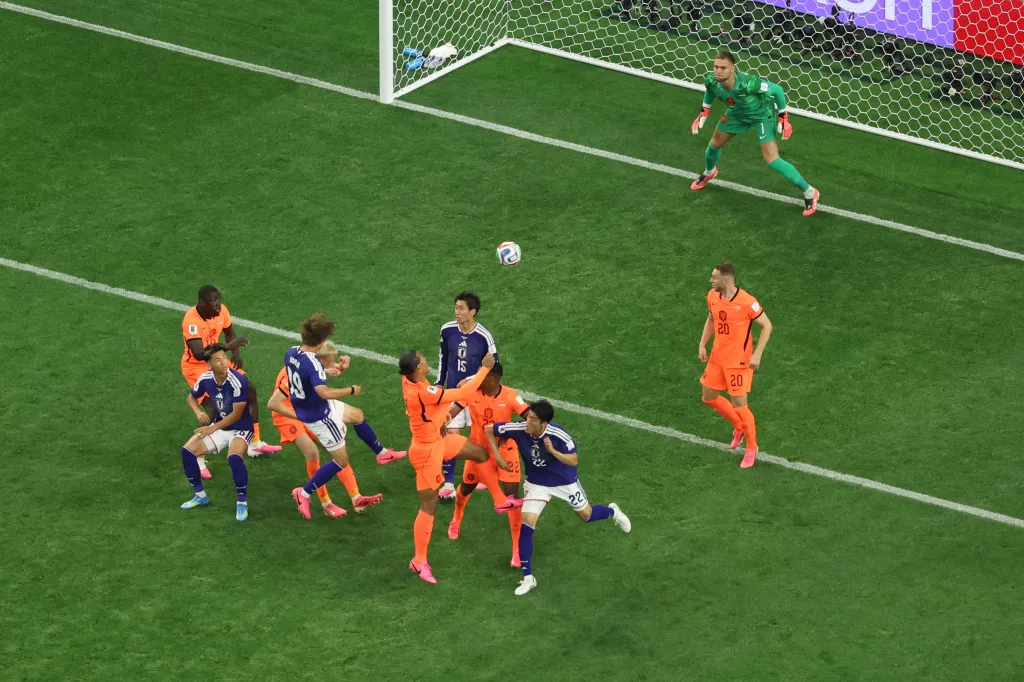 Japan's Daichi Kamada (15) scores a goal past Netherlands goalkeeper Bart Verbruggen (1).