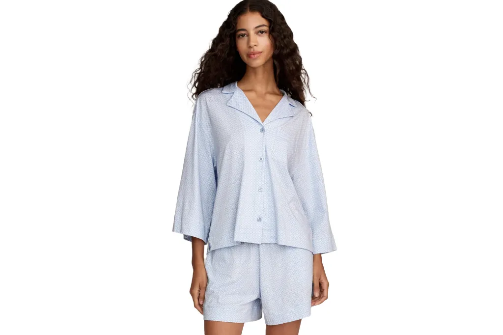 Woman in blue patterned pajama shorts and top.