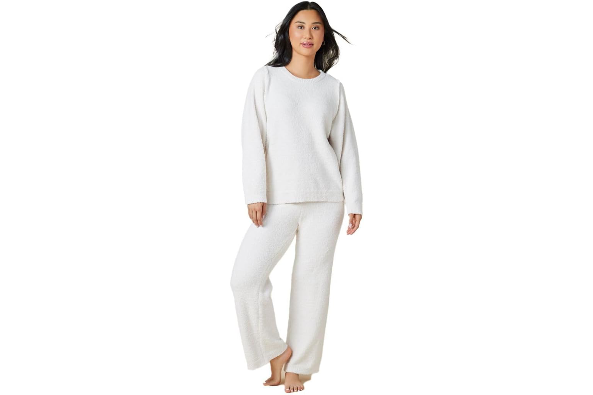 Woman modeling a soft white crewneck sweatshirt and matching pants.