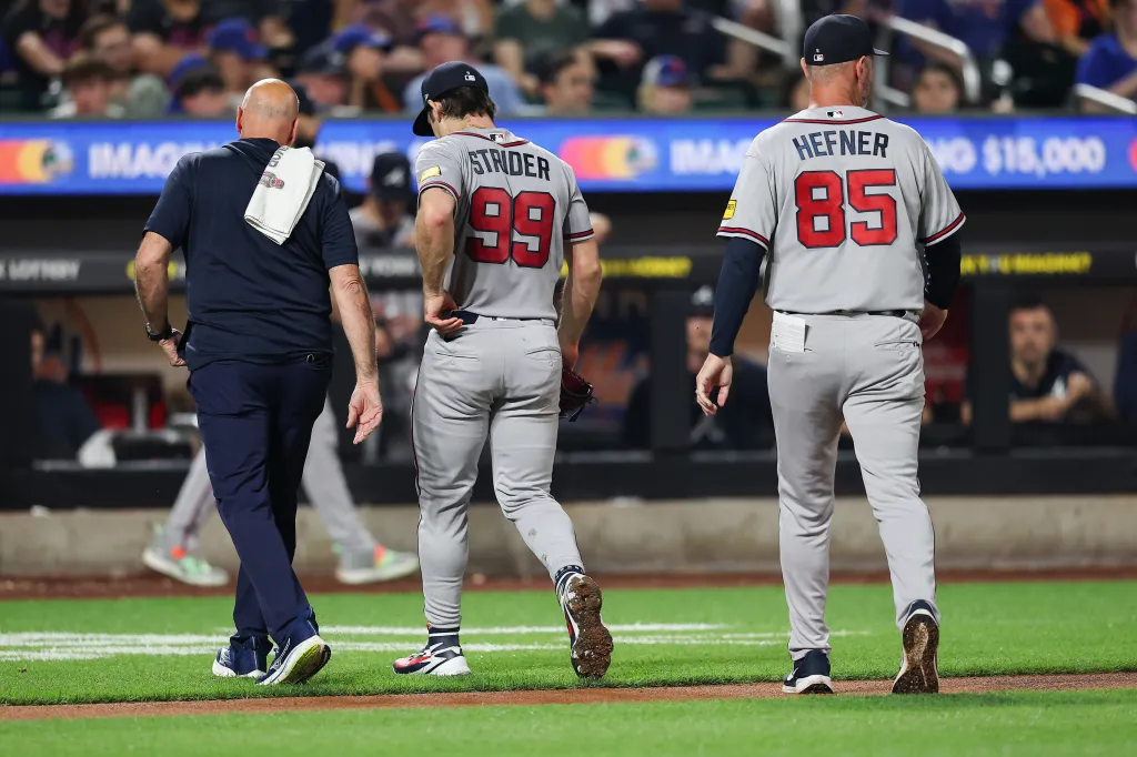 Spencer Strider #99 of the Atlanta Braves walks off the field after being removed from the game.
