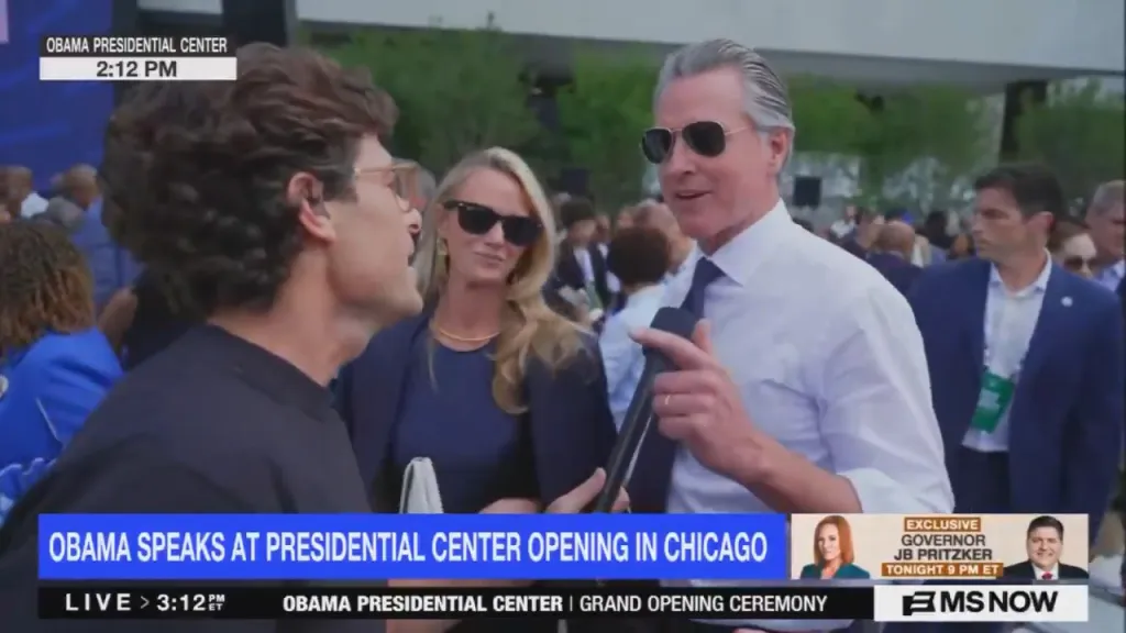 Gavin Newsom being interviewed by a reporter at the Obama Presidential Center opening in Chicago.