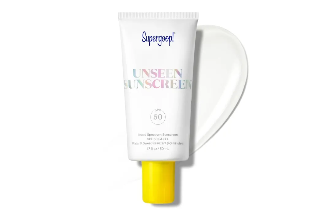 Supergoop! Unseen Sunscreen with SPF 50, a white tube with a yellow cap, with a white smear of sunscreen beside it.
