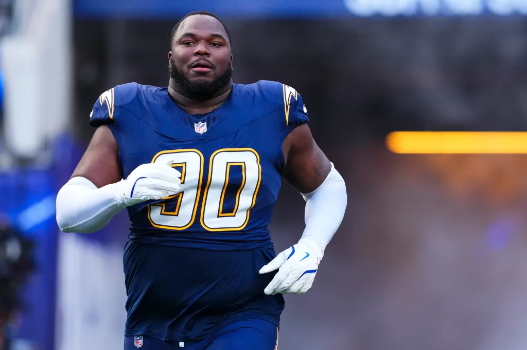 Teair Tart #90 of the Los Angeles Chargers runs onto the field.