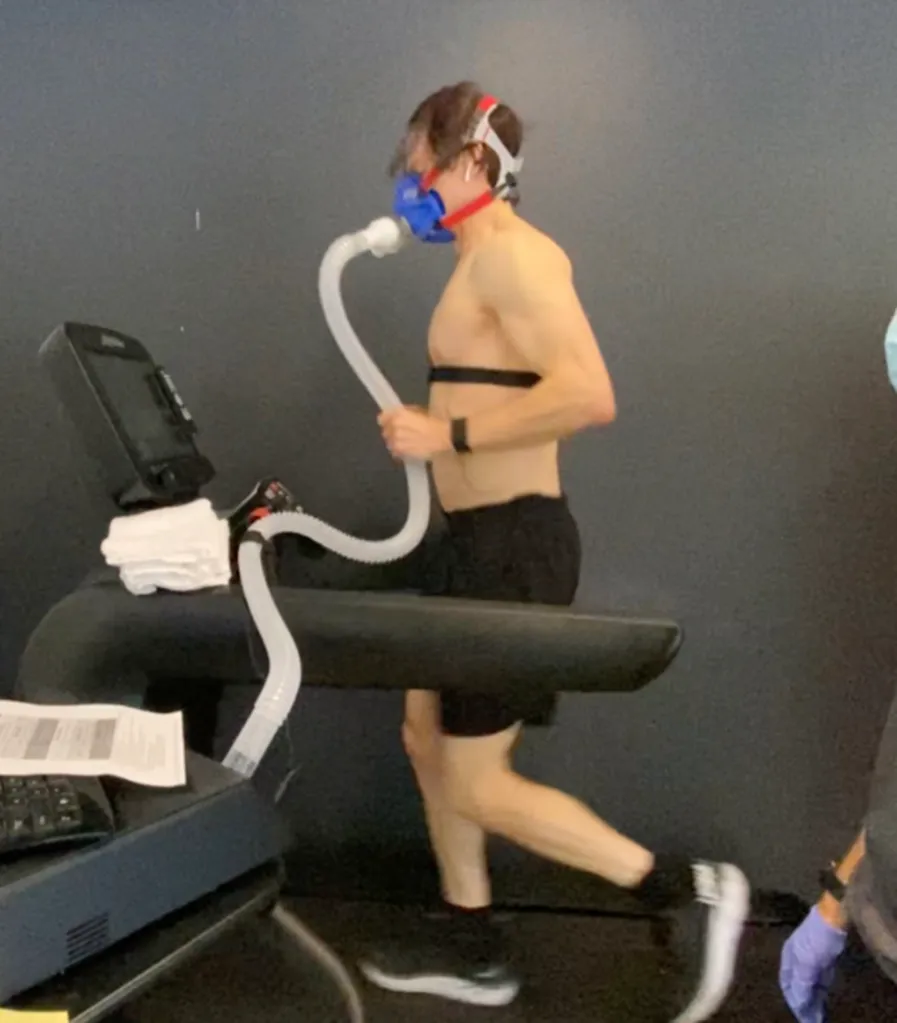 Bryan Johnson running on a treadmill with a mask and chest straps for a healthy living experiment.