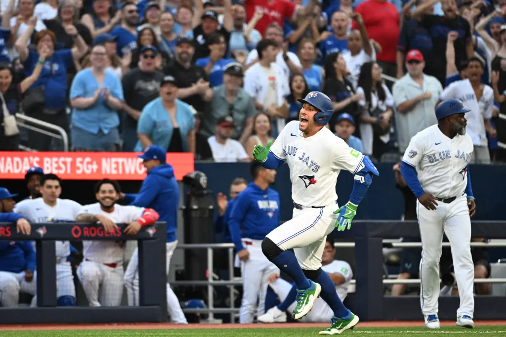 Toronto Blue Jays designated hitter George Springer running to score a run.