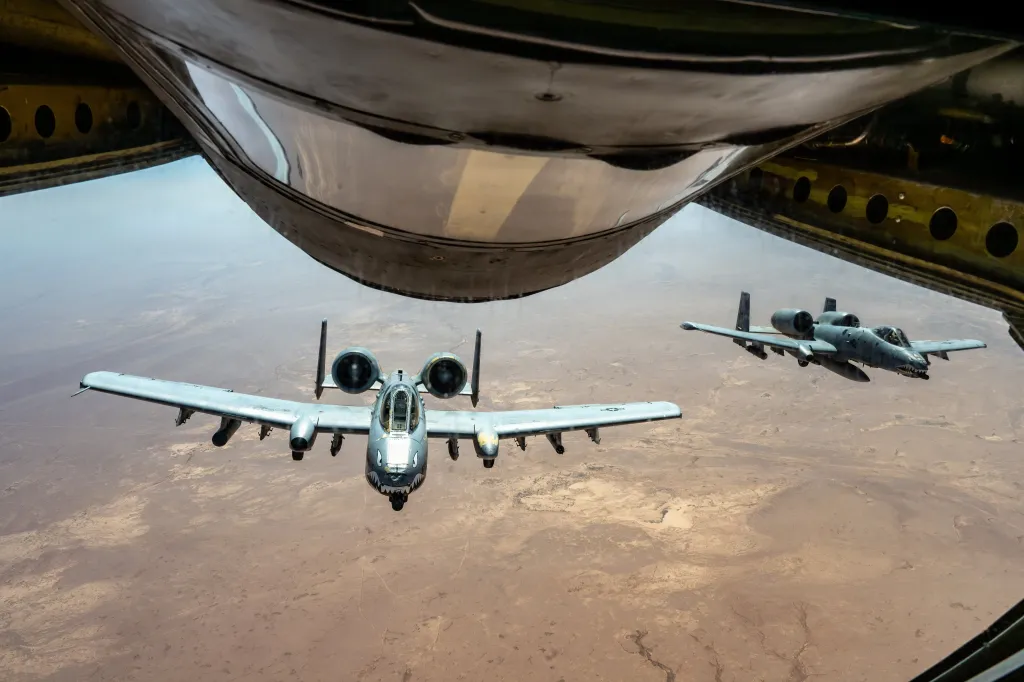 Two U.S. Air Force A-10 attack aircraft fly together over the Middle East during a routine patrol.