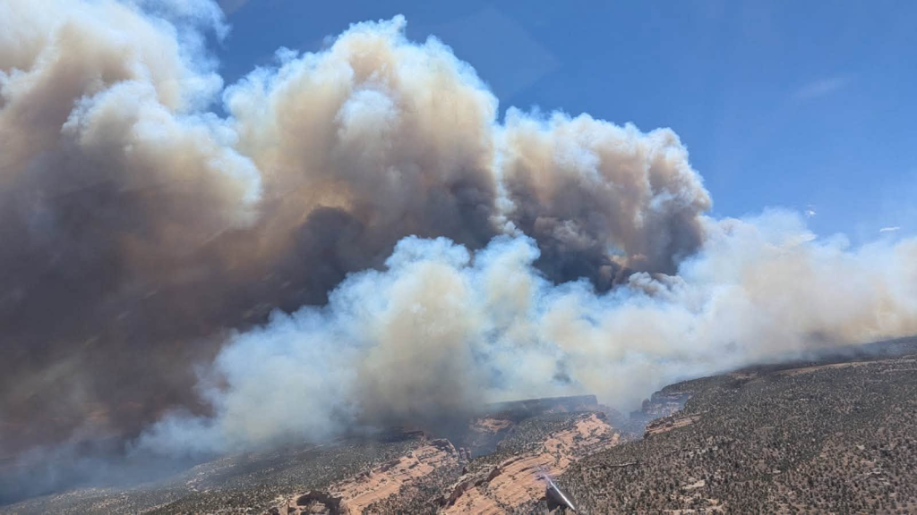 Smoke plumes from the Snyder Fire rise above mesas along the Utah-Colorado border.