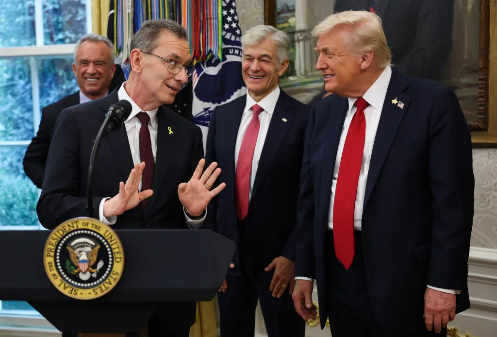 Pfizer CEO Albert Bourla speaking with President Donald Trump, Secretary of Health and Human Services Robert F. Kennedy Jr., and CMS Administrator Mehmet Oz in the Oval Office.