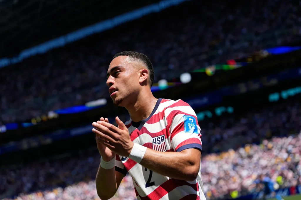 United States' Sergino Dest claps after being substituted during a soccer match.