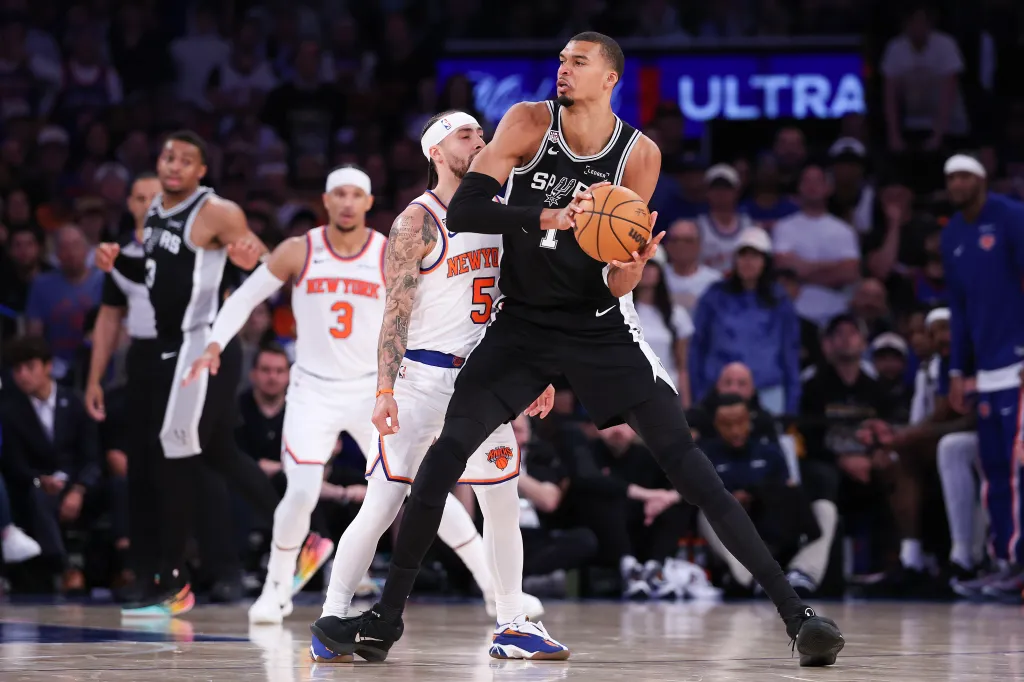 Victor Wembanyama of the San Antonio Spurs works against Jose Alvarado of the New York Knicks.