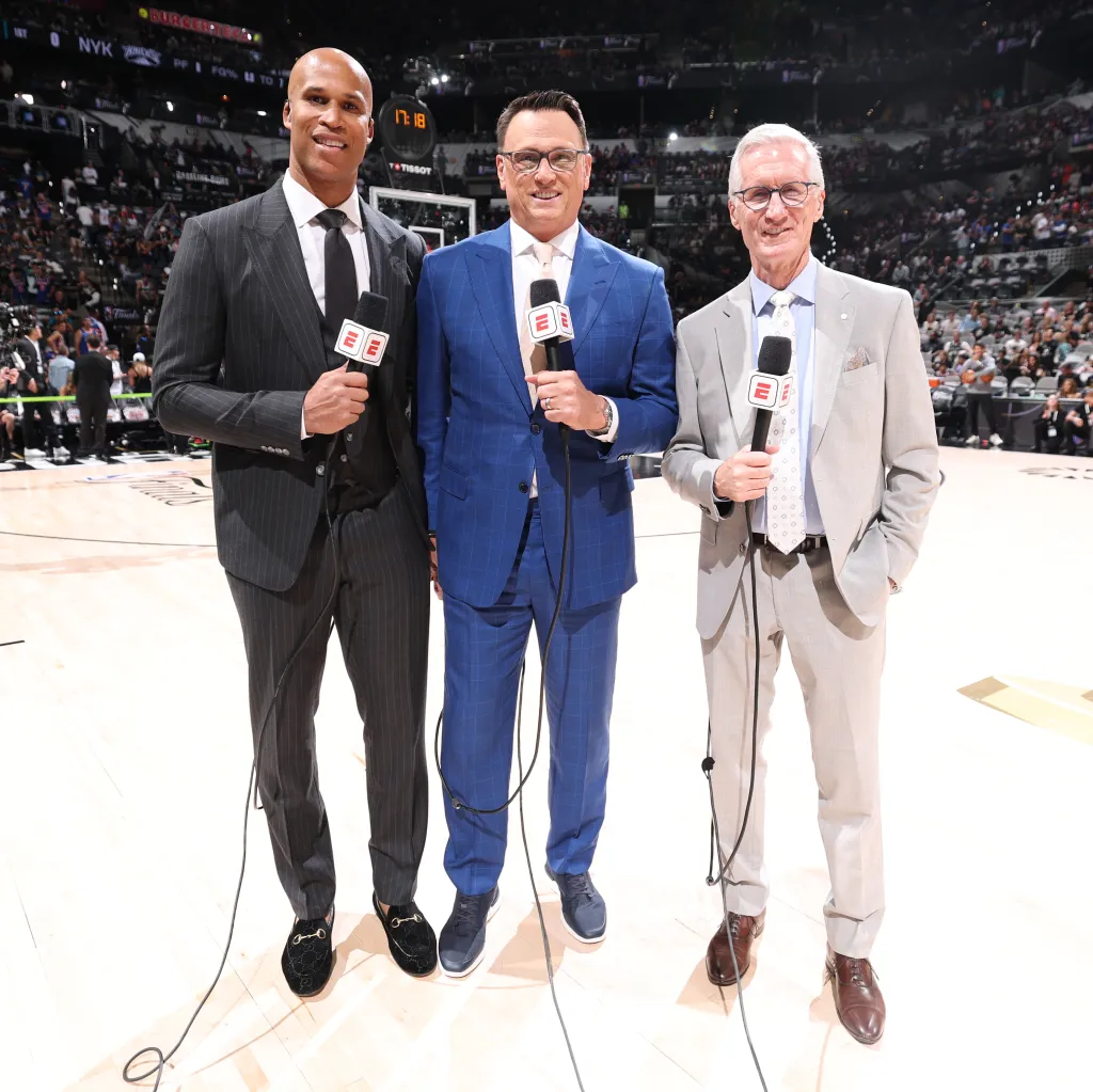 Richard Jefferson, Tim Legler, and Mike Breen posing for a photo on the basketball court.