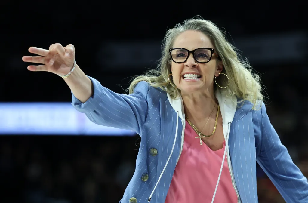 Las Vegas Aces head coach Becky Hammon gestures toward a referee during a game.