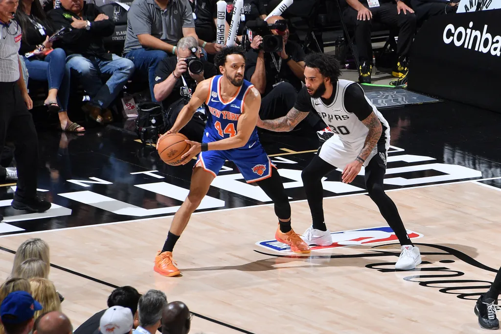 New York Knicks player Landry Shamet dribbles the ball against a San Antonio Spurs player during Game Five of the 2026 NBA Finals.