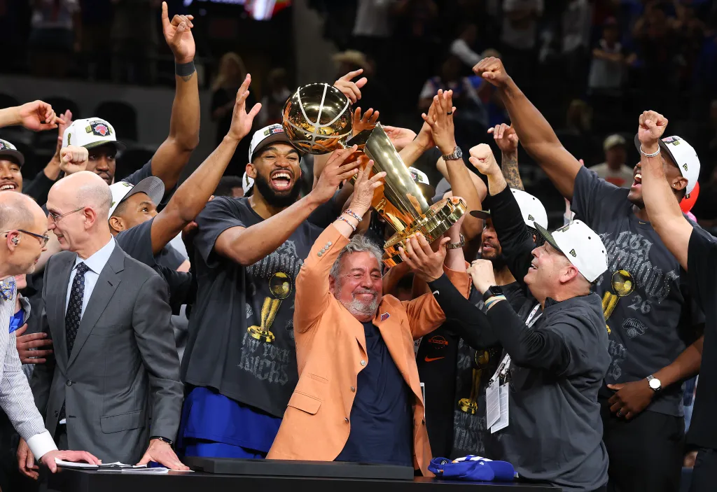 New York Knicks owner James Dolan and president Leon Rose lift the Larry O'Brien Championship Trophy.