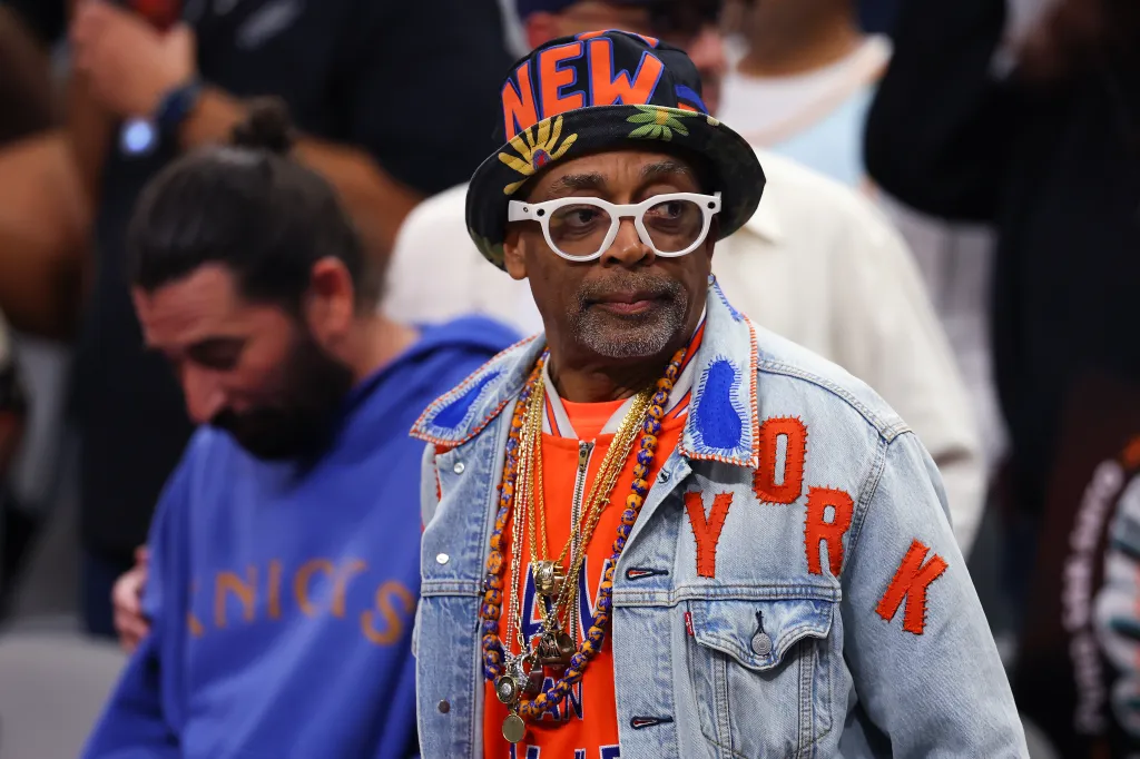 Spike Lee in a New York Knicks hat and denim jacket.