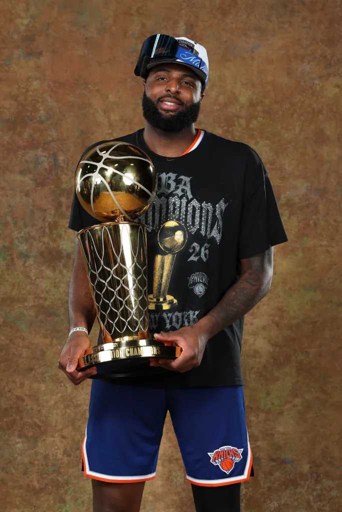 Knicks center Mitchell Robinson poses with the Larry O'Brien trophy after the team's NBA championship win on June 13, 2026.