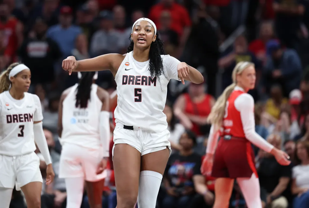 Angel Reese #5 of the Atlanta Dream celebrates in a WNBA basketball game.