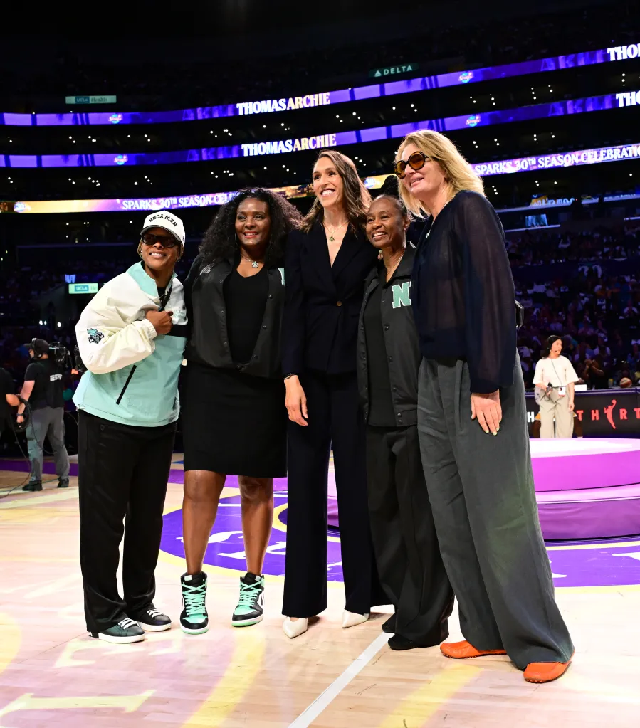 Five women from the New York Liberty pose for a photo on the court during the Los Angeles Sparks' 30th season anniversary ceremony.