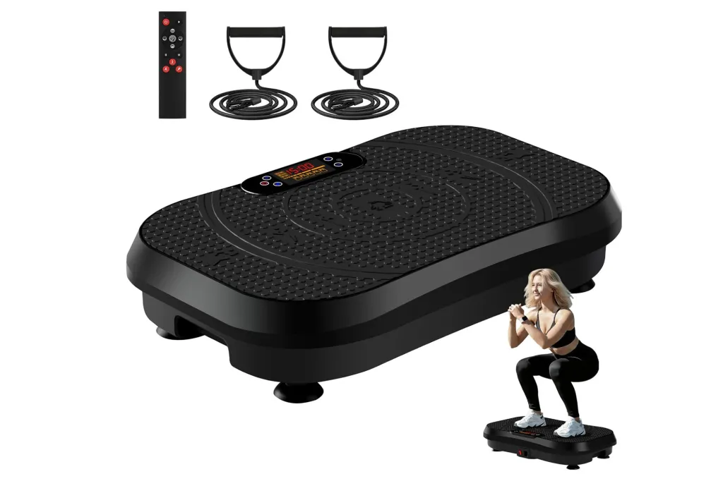 Black vibration plate machine with resistance bands, remote control, and a woman squatting on the plate.