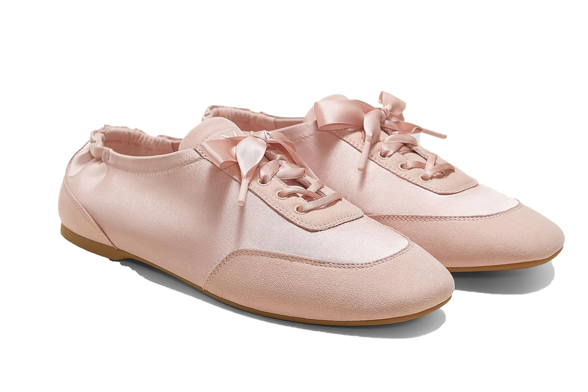 Pair of pink satin sneakers with ribbon laces and suede accents.