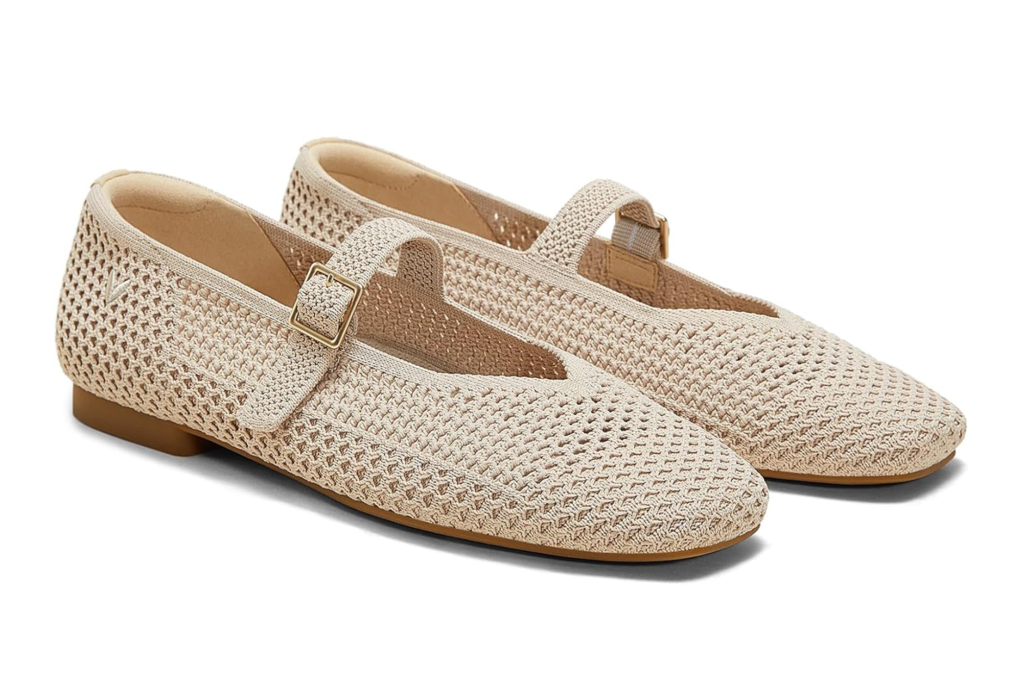 Pair of beige knit Mary Jane flats with buckled straps.