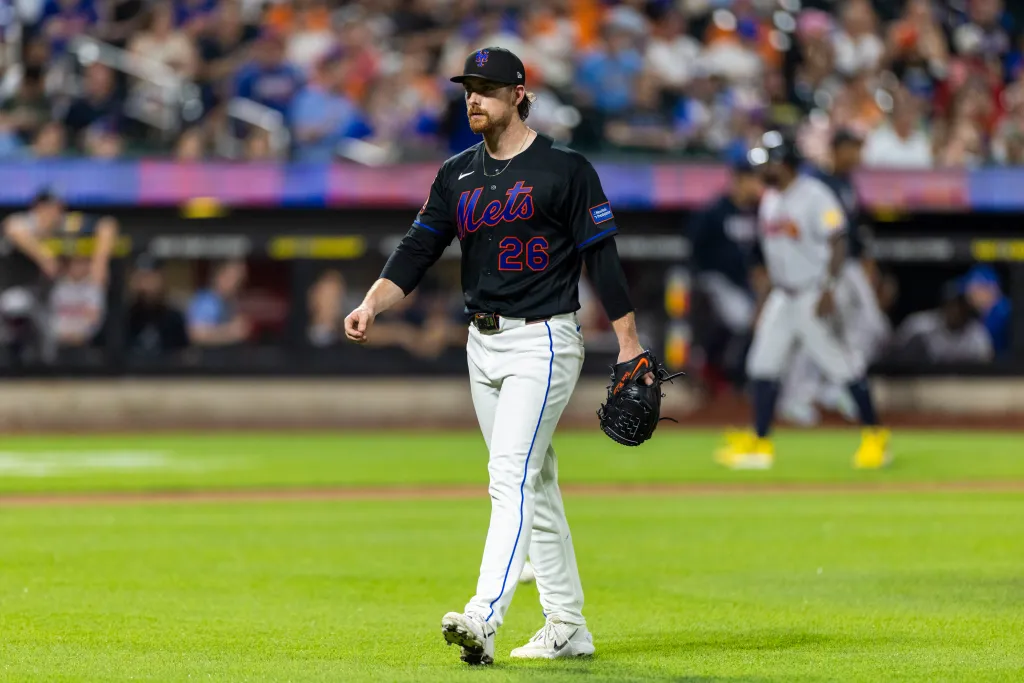 New York Mets pitcher Nolan McLean walks to the dugout in the fourth inning.