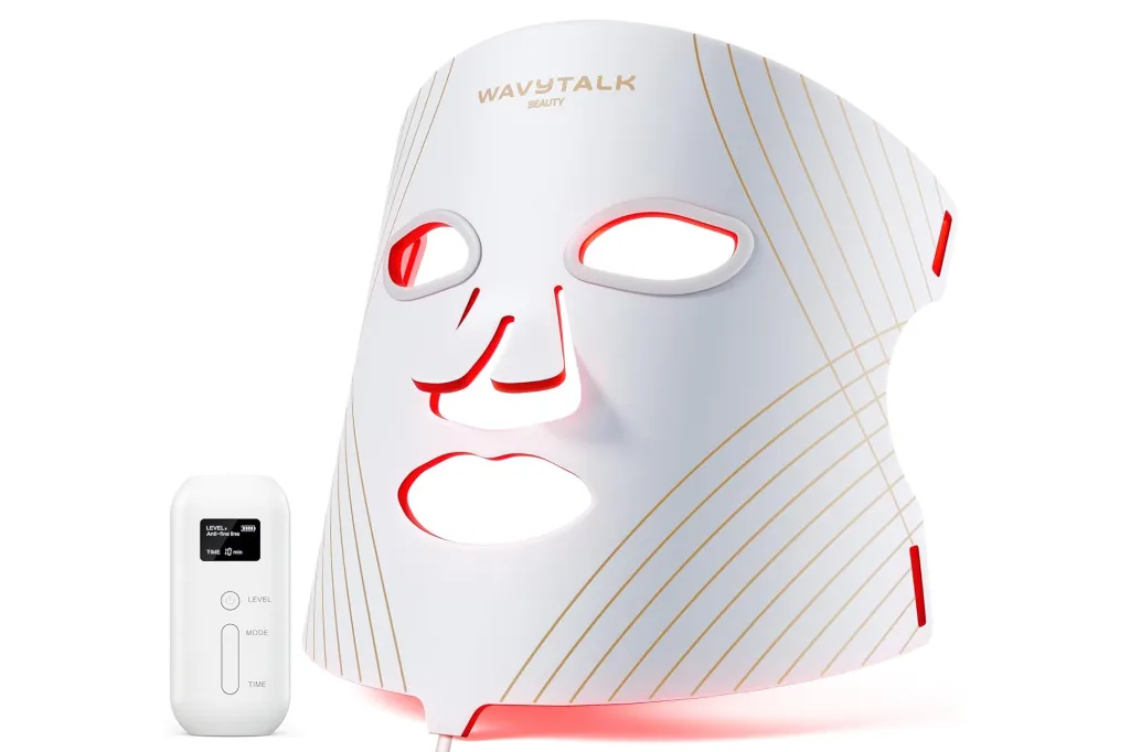 White LED light therapy mask with red lights on the inside, and a white remote control.
