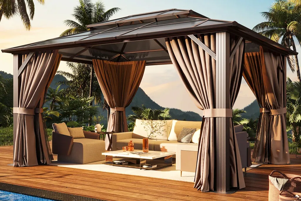 Outdoor patio gazebo with full curtains and seating area overlooking a tropical landscape.