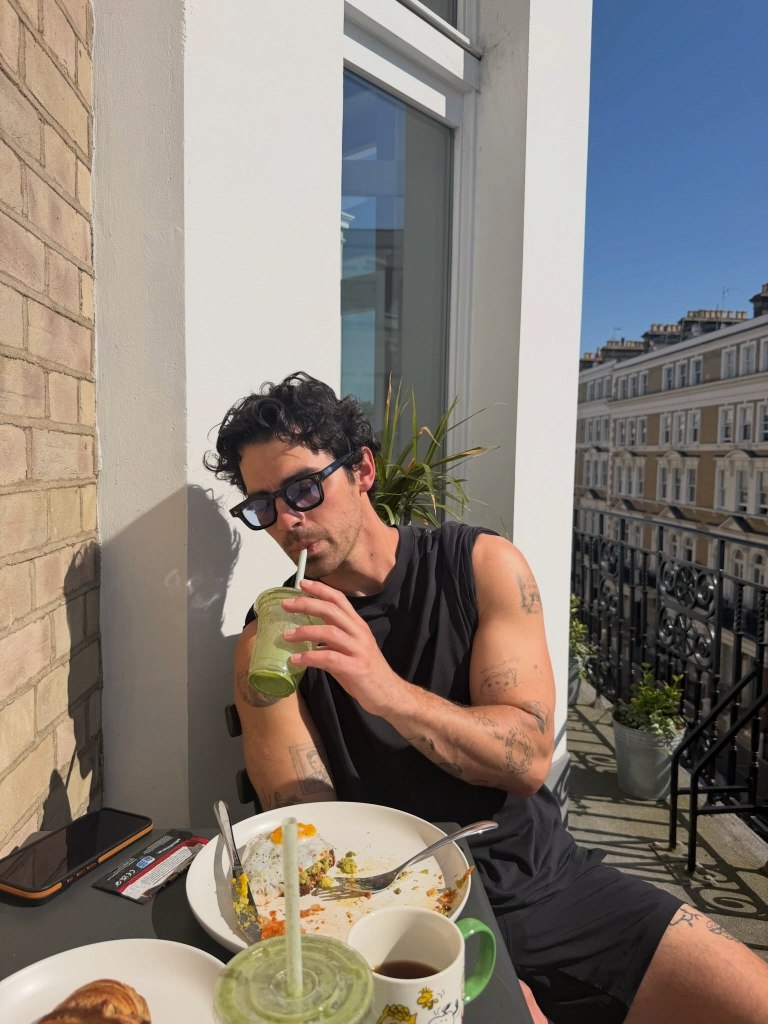 Joe Jonas sips some matcha while enjoying his brunch outdoors.
