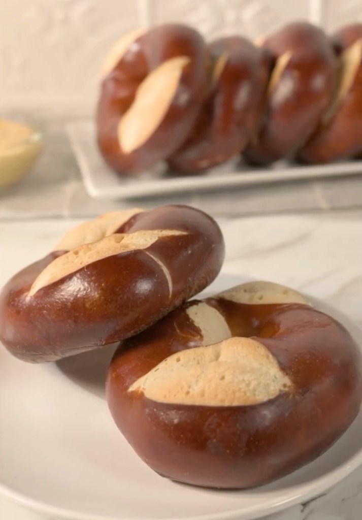 Pretzel bagels with a side of mustard.