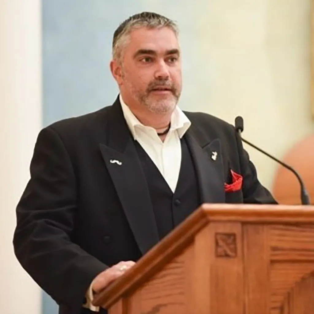 Terry Maccarrone speaking at a podium.
