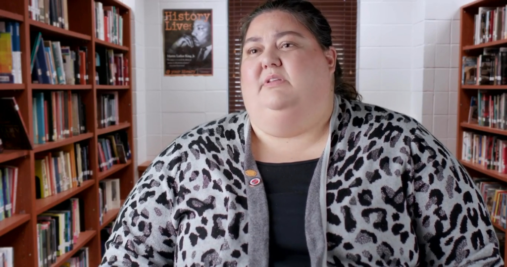 Meghan Lefevers sitting in a library.